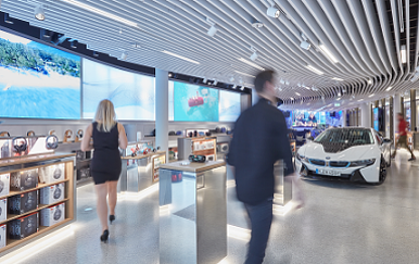 A man and woman walking in a store.
